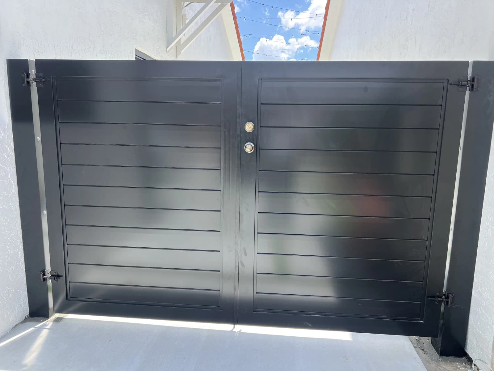 Modern black aluminum driveway gate